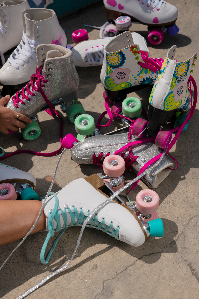 Woman Surrounded with Pairs of Roller Skates